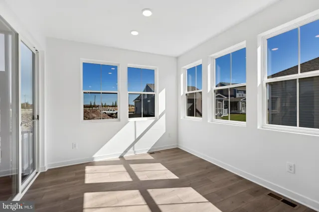 a view of kitchen with refrigerator and window