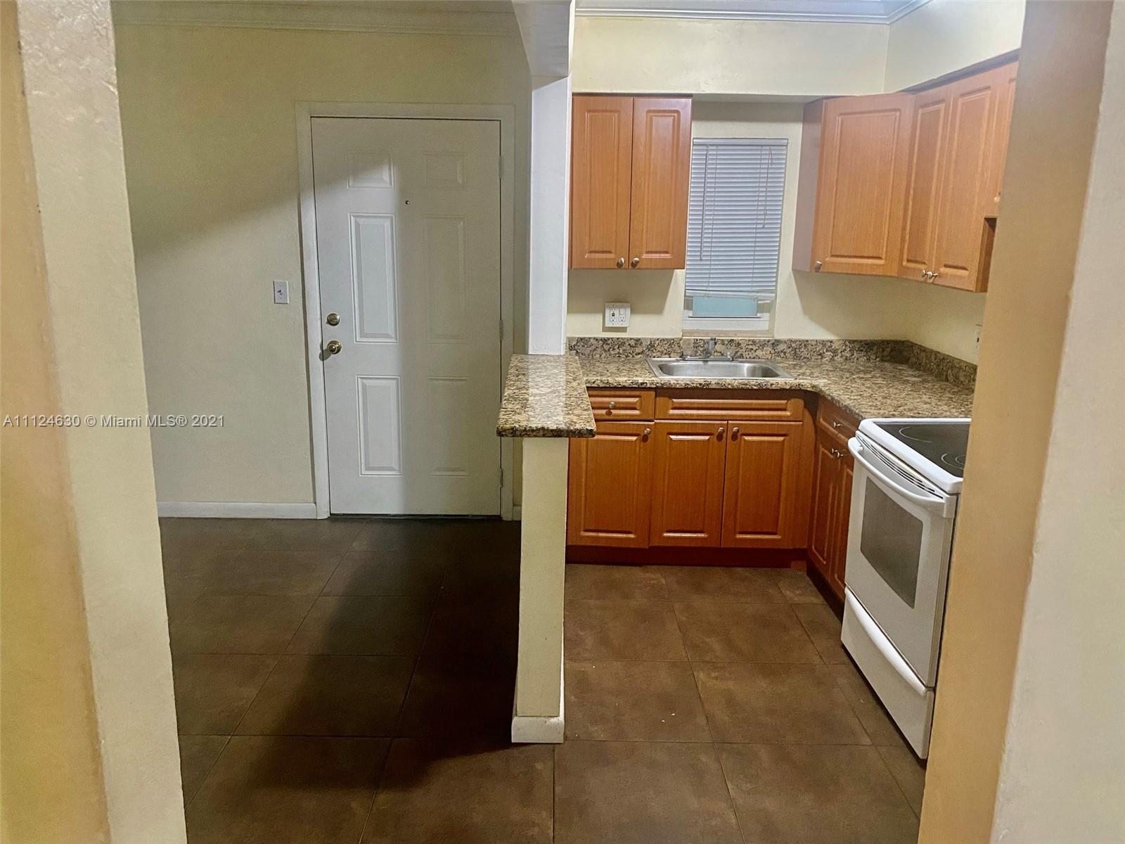 520 Northeast 82nd Terrace, Unit 7 Miami, FL 33138 - Photo 5 of 11 a kitchen with a refrigerator sink and stove