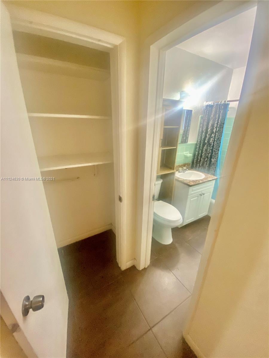 520 Northeast 82nd Terrace, Unit 7 Miami, FL 33138 - Photo 7 of 11 a bathroom with a toilet and a shower