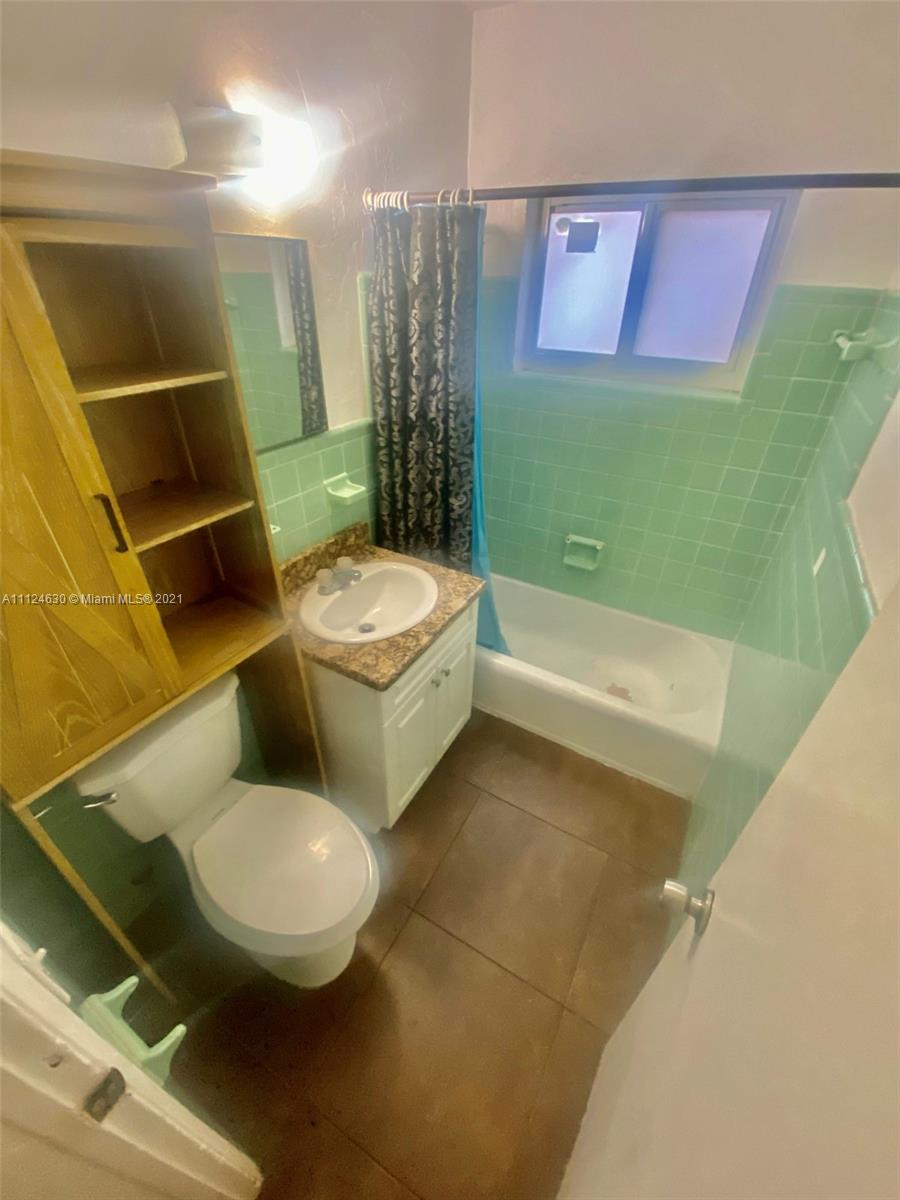 520 Northeast 82nd Terrace, Unit 7 Miami, FL 33138 - Photo 9 of 11 a bathroom with a toilet sink and mirror