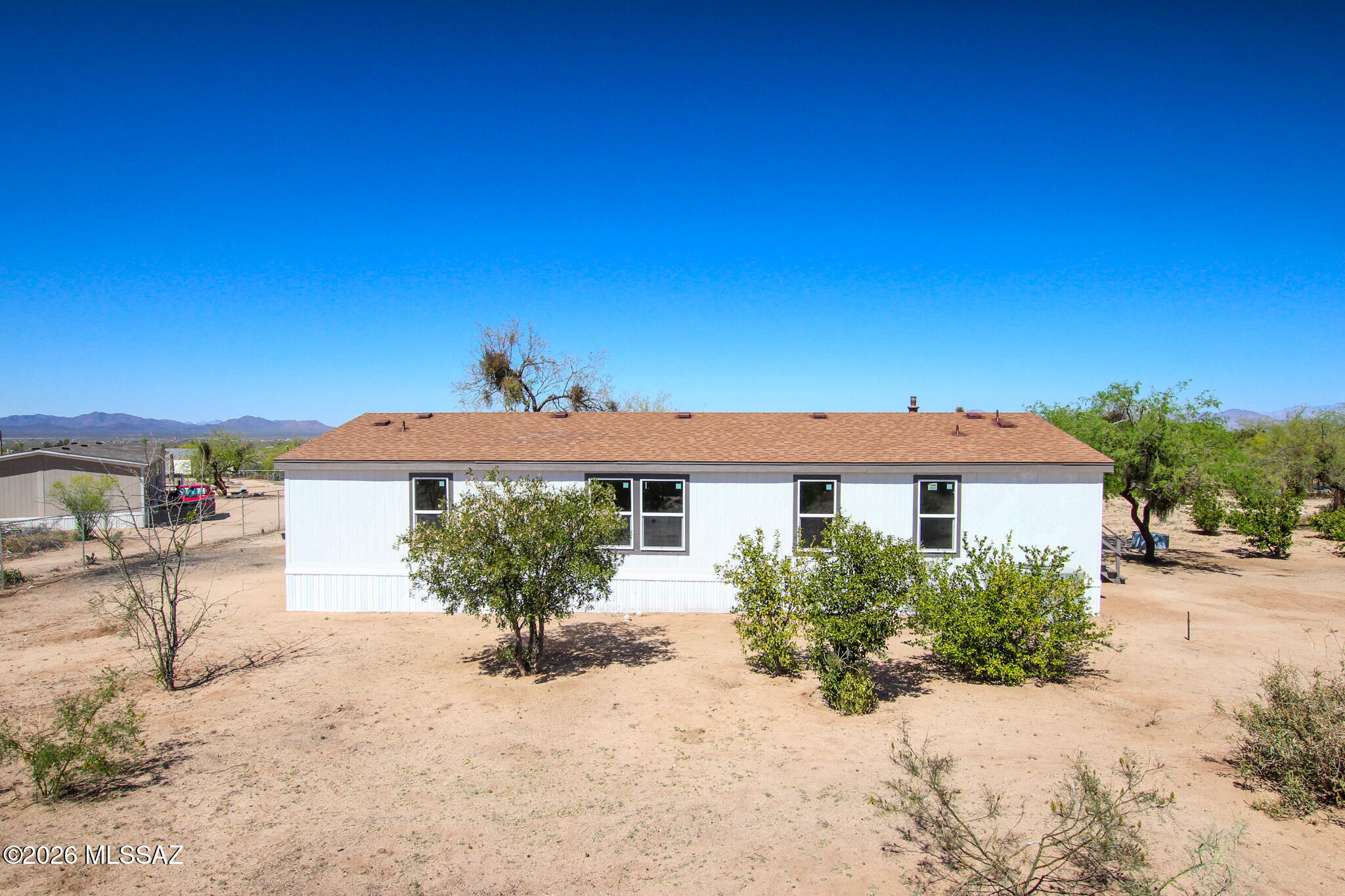 14303 West Rolina Lane Tucson, AZ 85736 - Photo 34 of 38 a front view of a house with a yard