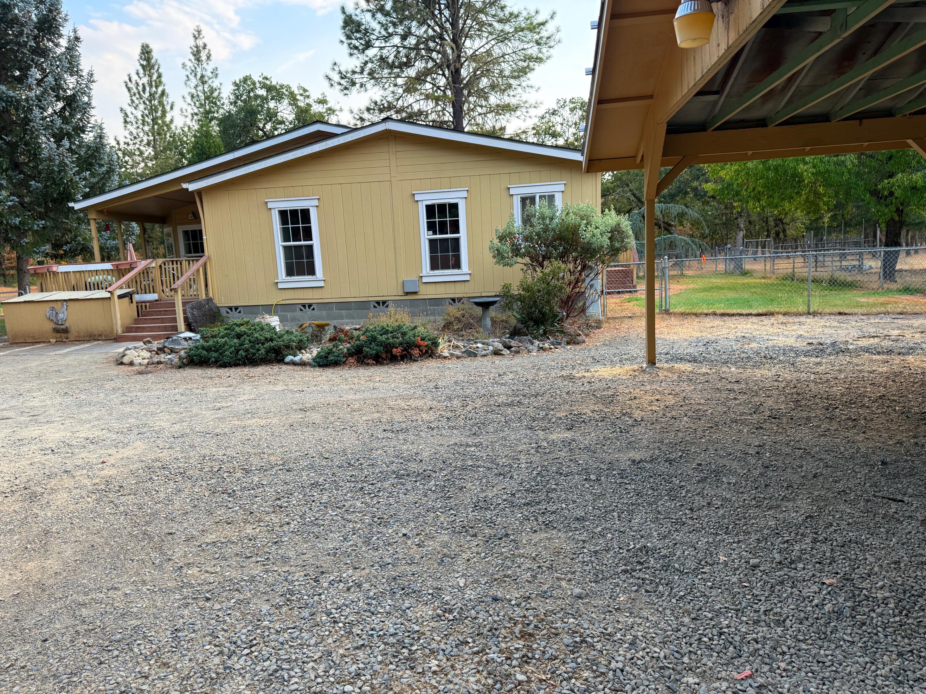 1800 Dick George Road Cave Junction, OR 97523 - Photo 2 of 37 close view of home, cov deck, carport