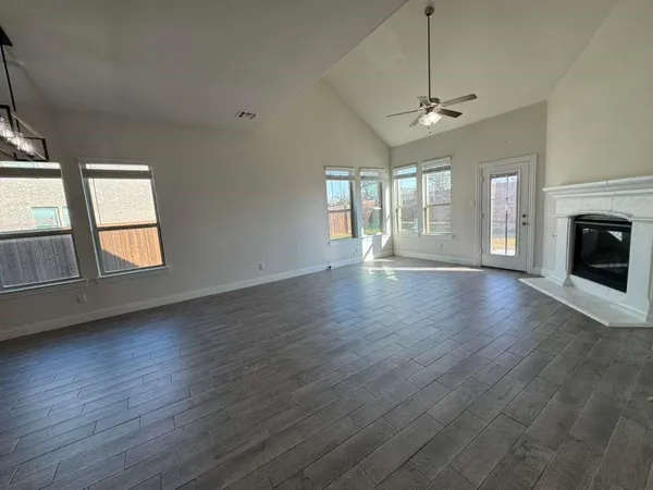 a kitchen with stainless steel appliances kitchen island granite countertop a stove a sink and a refrigerator