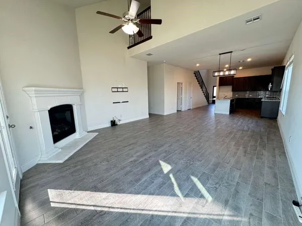 a large kitchen with granite countertop a sink and a stove