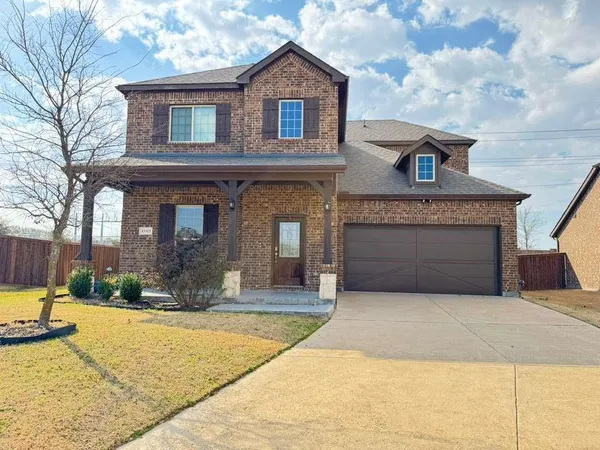 a front view of a house with yard and garage