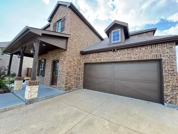a front view of a house with garage