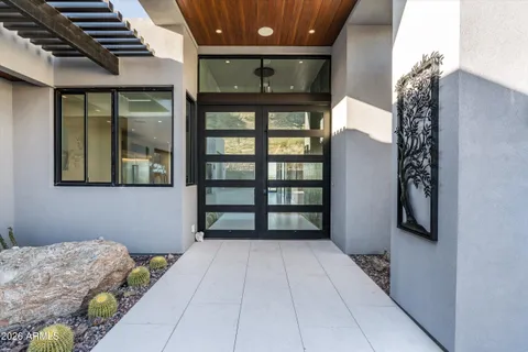 a kitchen with stainless steel appliances kitchen island granite countertop a table chairs sink and cabinets