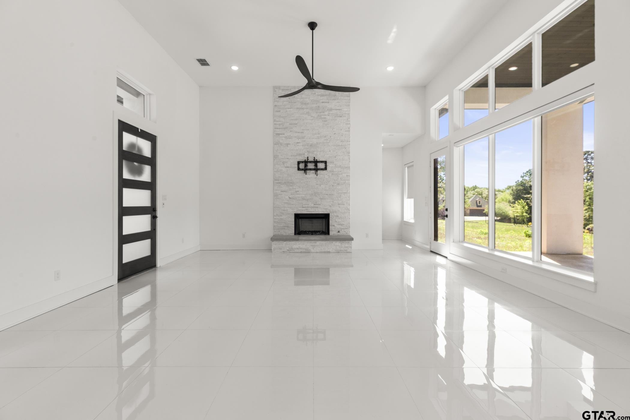 2854 J J.Cupit Court Tyler, TX 75709 - Photo 22 of 48 a view of an empty room with a fireplace and windows