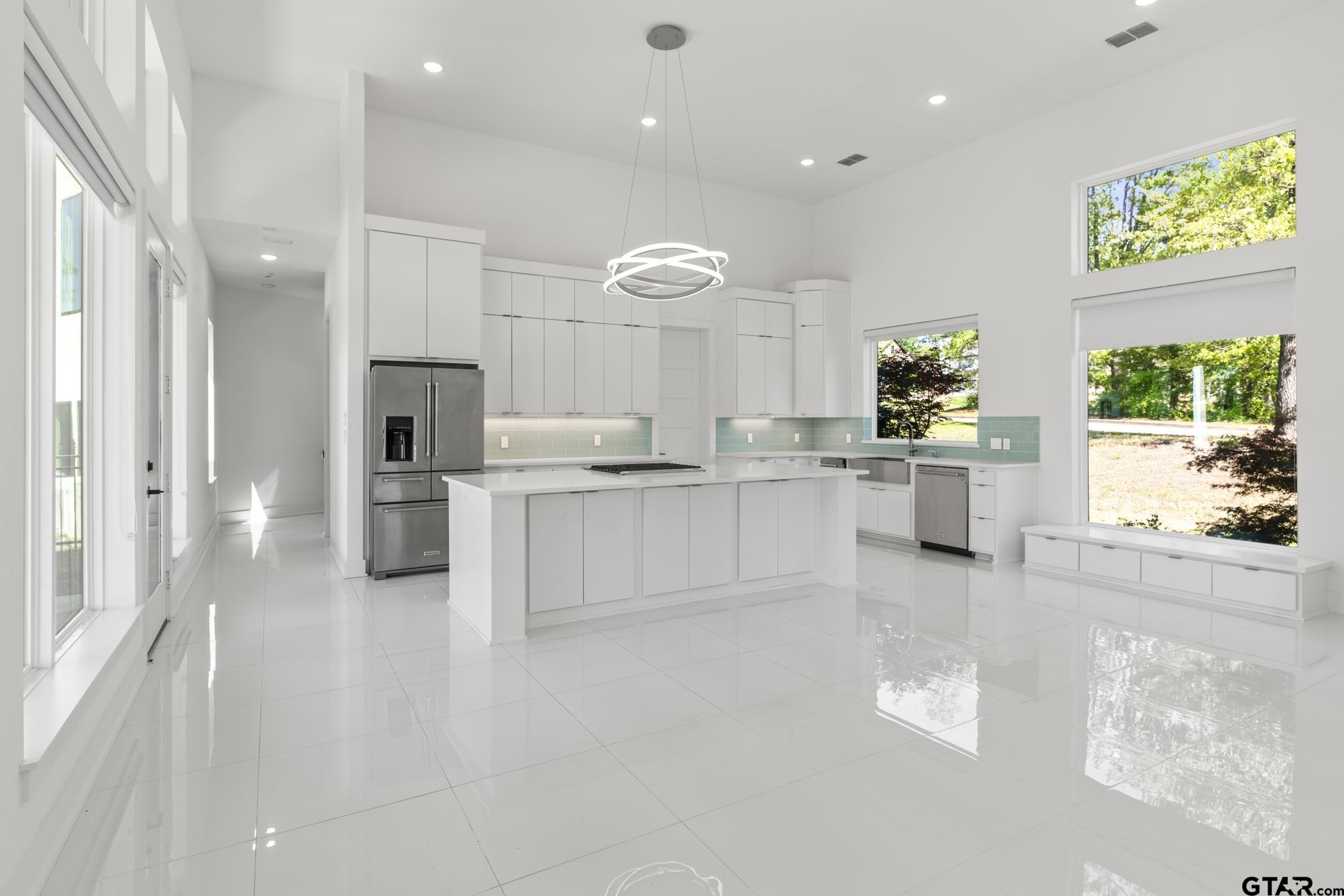 2854 J J.Cupit Court Tyler, TX 75709 - Photo 24 of 48 a large white kitchen with a refrigerator a stove a sink and a cabinets
