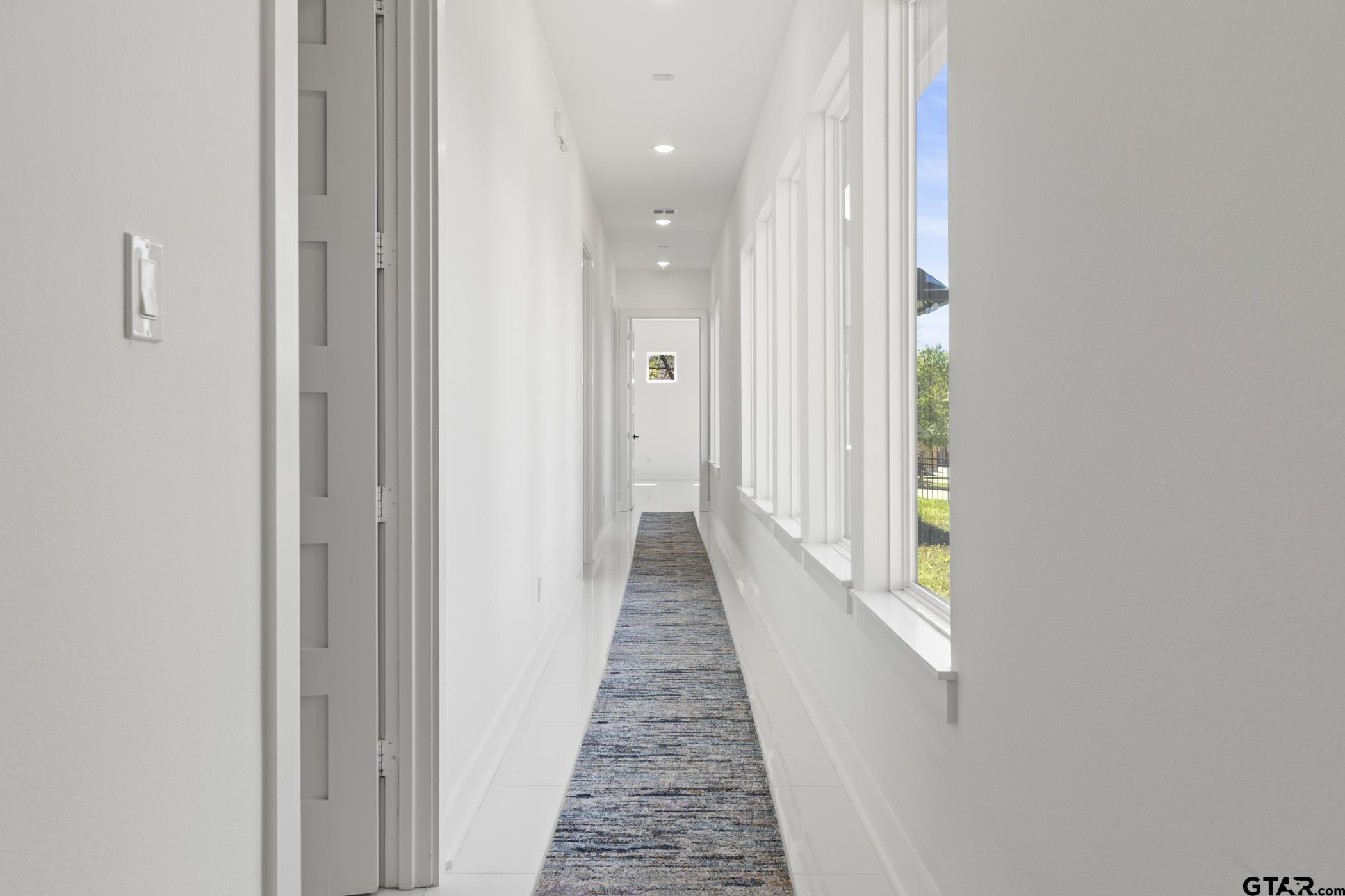 2854 J J.Cupit Court Tyler, TX 75709 - Photo 26 of 48 a view of a hallway with wooden floor and a bathroom