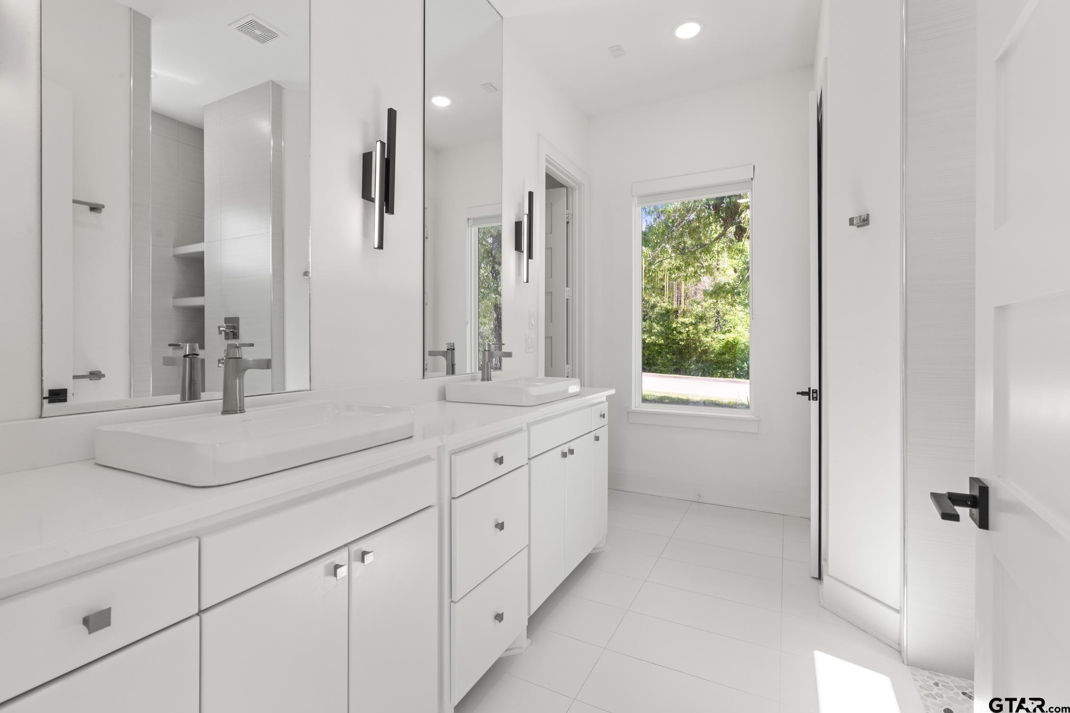 2854 J J.Cupit Court Tyler, TX 75709 - Photo 29 of 48 a bathroom with a sink and a mirror