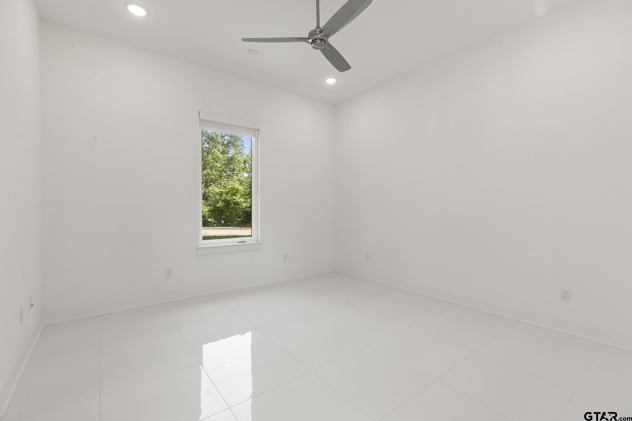 2854 J J.Cupit Court Tyler, TX 75709 - Photo 33 of 48 an empty room with a window and a ceiling fan