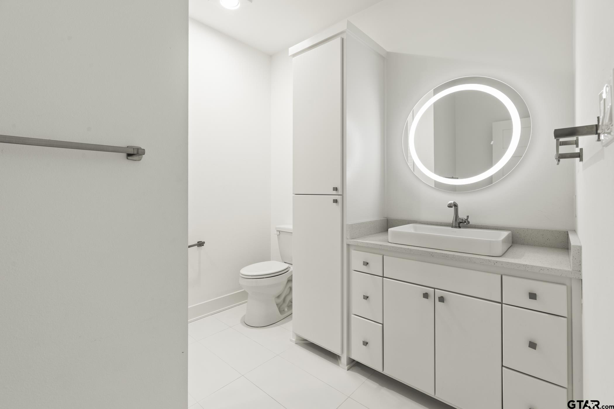 2854 J J.Cupit Court Tyler, TX 75709 - Photo 44 of 48 a bathroom with a toilet a sink and mirror