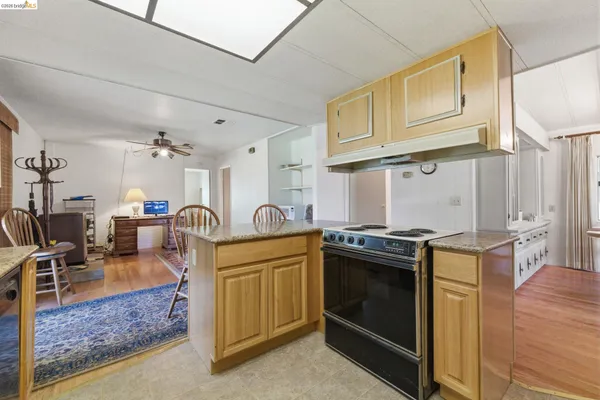 a kitchen with stainless steel appliances granite countertop a stove and a sink