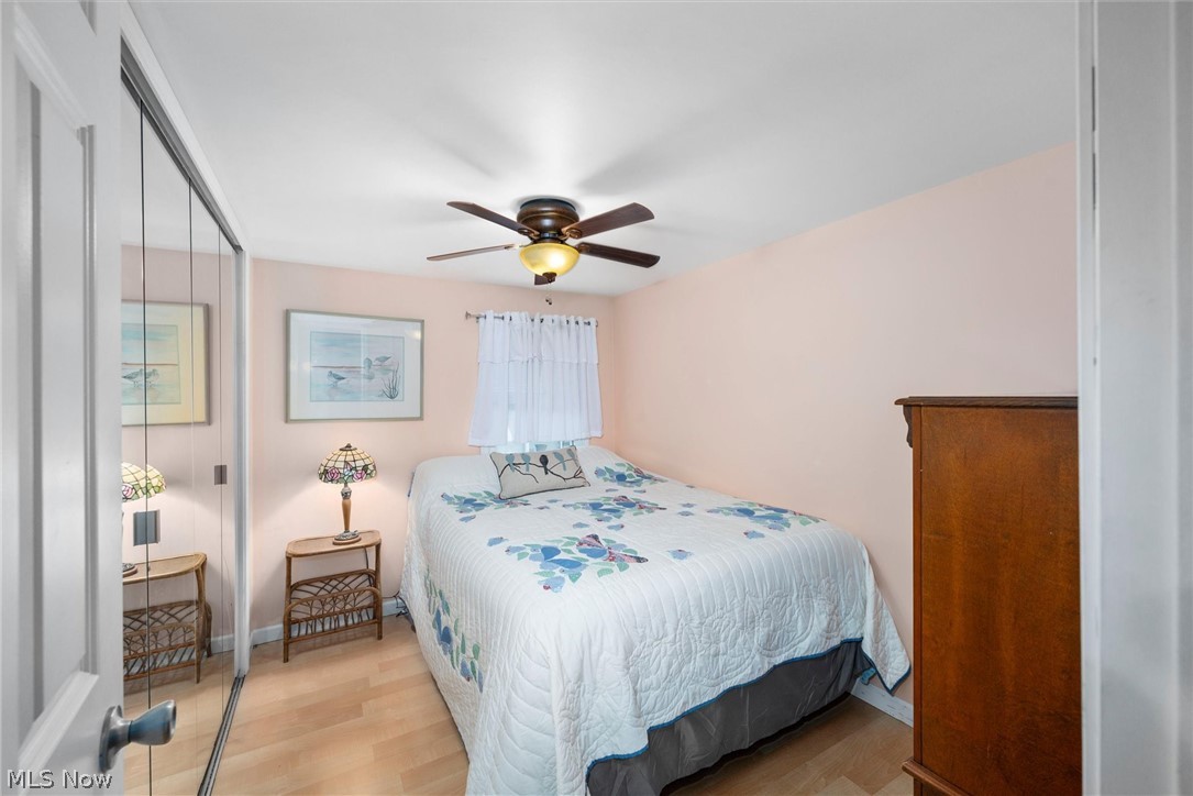 1623 Northeast Catawba Road, Unit 160 Port Clinton, OH 43452 - Photo 15 of 28 Bedroom with a closet, light wood laminate floors, and a ceiling fan
