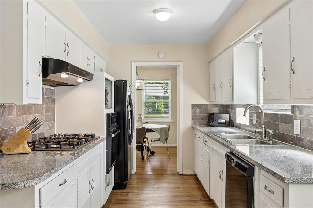 8049 Woodhue Road Dallas, TX 75228 - Photo 12 of 24 a kitchen with a sink stove and cabinets
