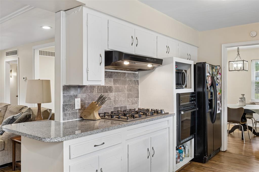 8049 Woodhue Road Dallas, TX 75228 - Photo 13 of 24 a kitchen with stainless steel appliances granite countertop a sink a stove and a refrigerator