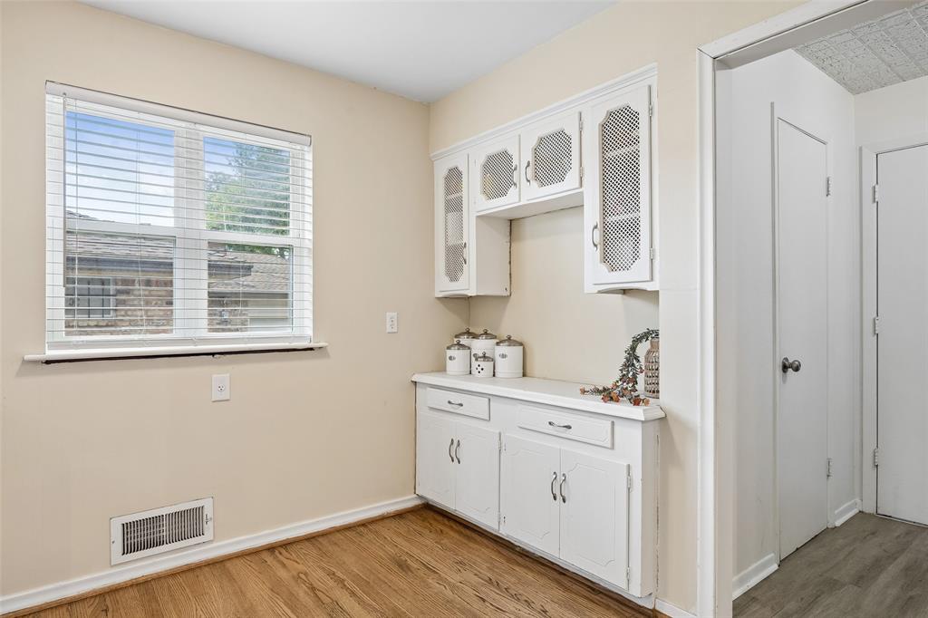 8049 Woodhue Road Dallas, TX 75228 - Photo 16 of 24 a view of cabinets with wooden floor