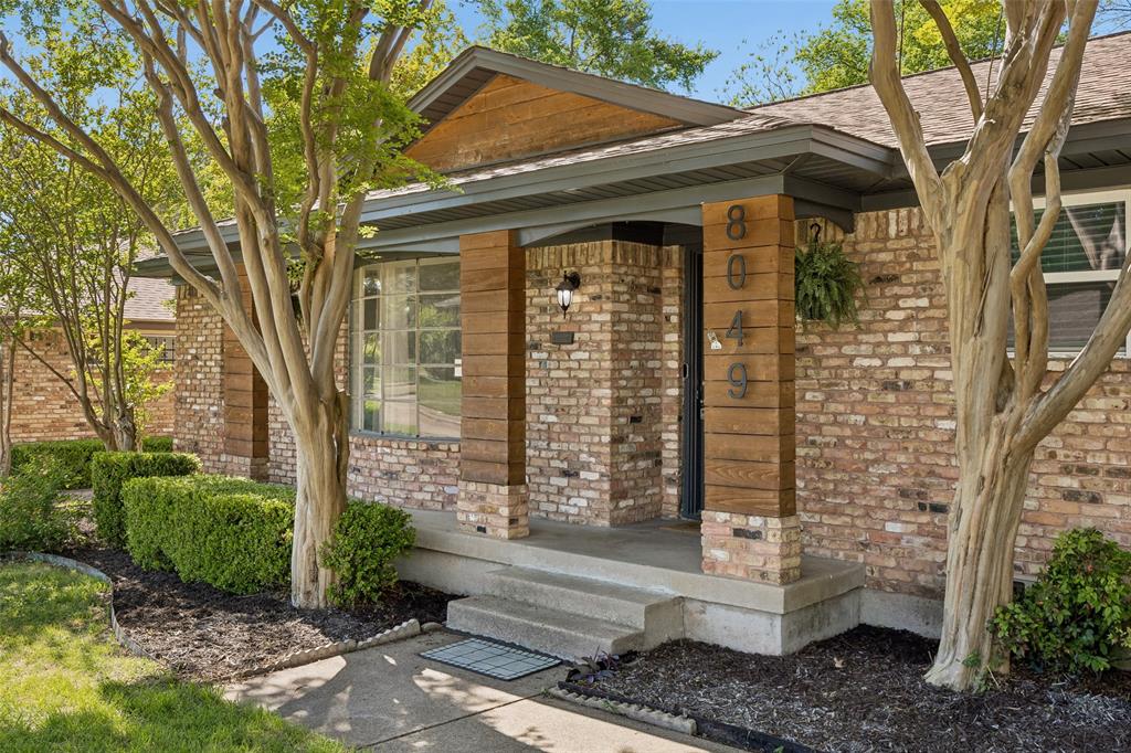 8049 Woodhue Road Dallas, TX 75228 - Photo 2 of 24 a front view of a house with a garden
