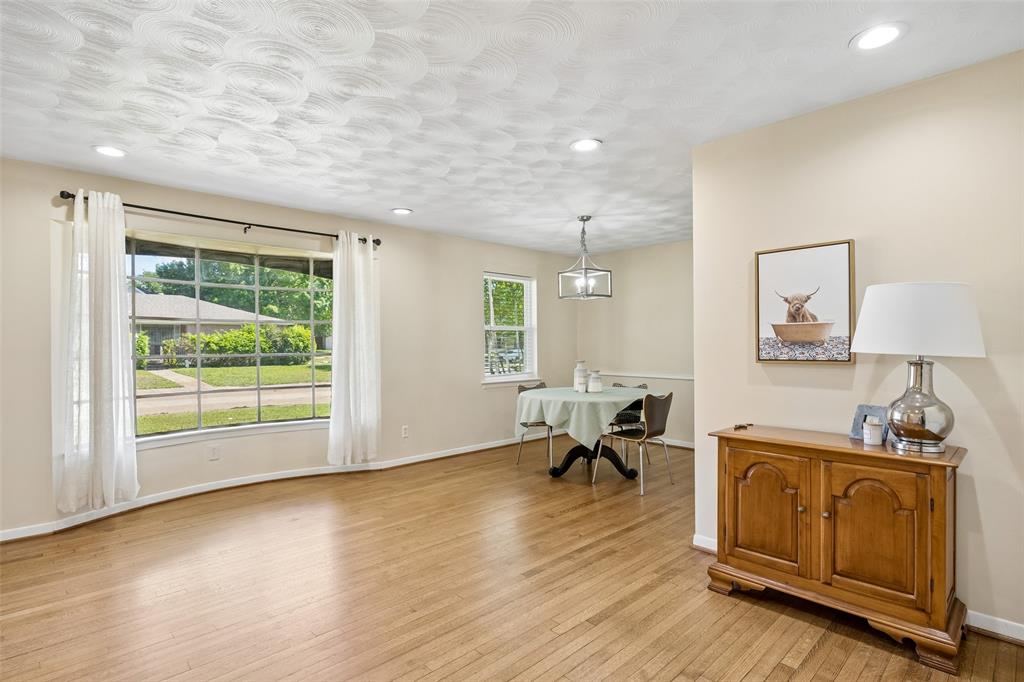 8049 Woodhue Road Dallas, TX 75228 - Photo 8 of 24 a living room with furniture and a wooden floor