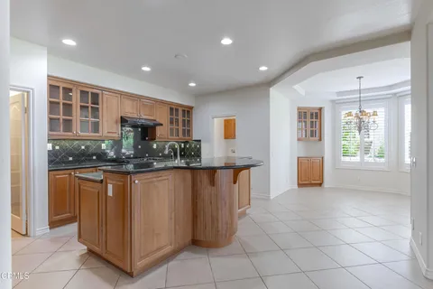 a kitchen with stainless steel appliances a refrigerator sink and cabinets