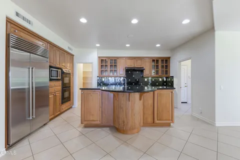 a kitchen with stainless steel appliances granite countertop a stove and a sink