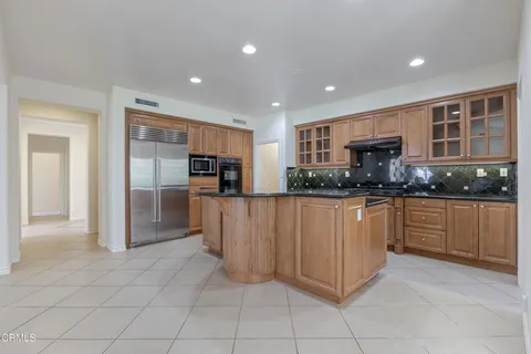 a kitchen with stainless steel appliances granite countertop a sink a stove and a wooden floors