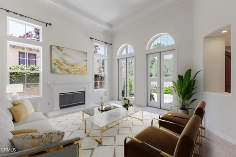 a living room with a fireplace and a window