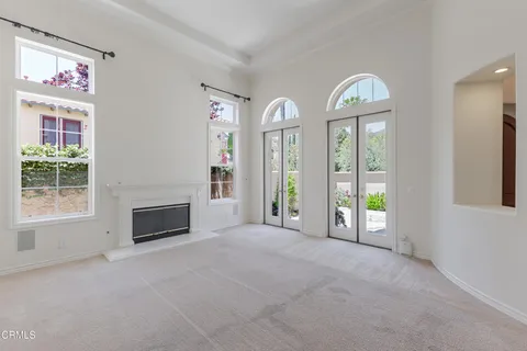 a view of a hallway with chandelier and entryway