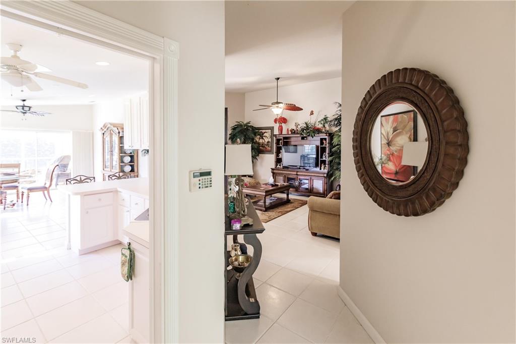 4113 Tabago Lane Naples, FL 34119 - Photo 11 of 50 Corridor featuring light tile patterned flooring