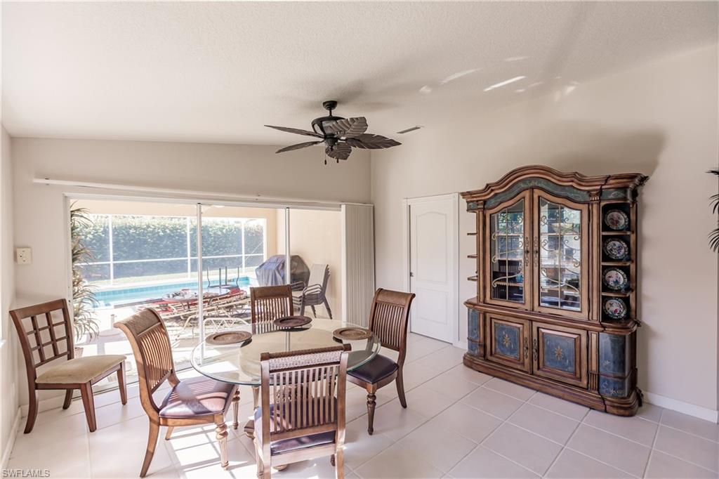 4113 Tabago Lane Naples, FL 34119 - Photo 18 of 50 Tiled dining room featuring ceiling fan and lofted ceiling