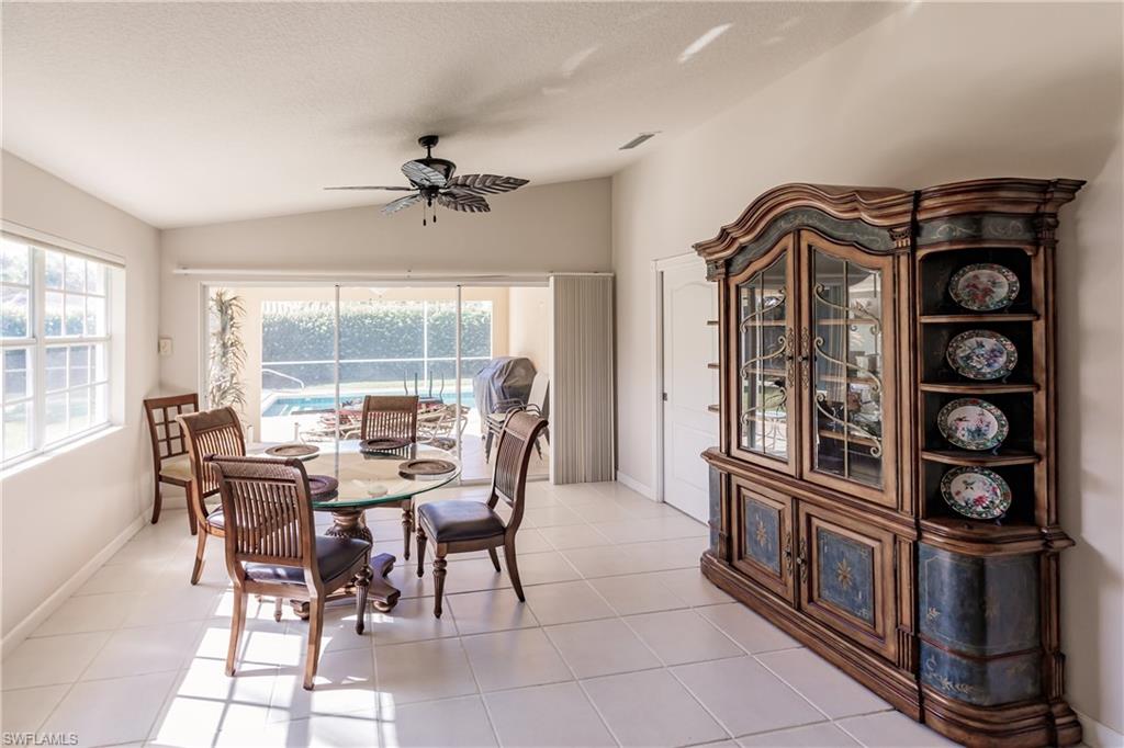 4113 Tabago Lane Naples, FL 34119 - Photo 22 of 50 Tiled dining room featuring ceiling fan and lofted ceiling