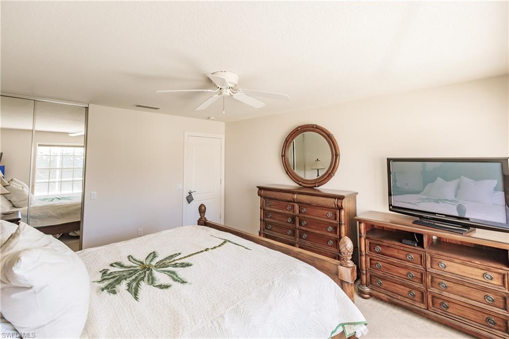 4113 Tabago Lane Naples, FL 34119 - Photo 25 of 50 Bedroom featuring carpet and ceiling fan