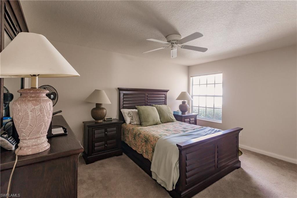 4113 Tabago Lane Naples, FL 34119 - Photo 29 of 50 Carpeted bedroom with a textured ceiling and ceiling fan