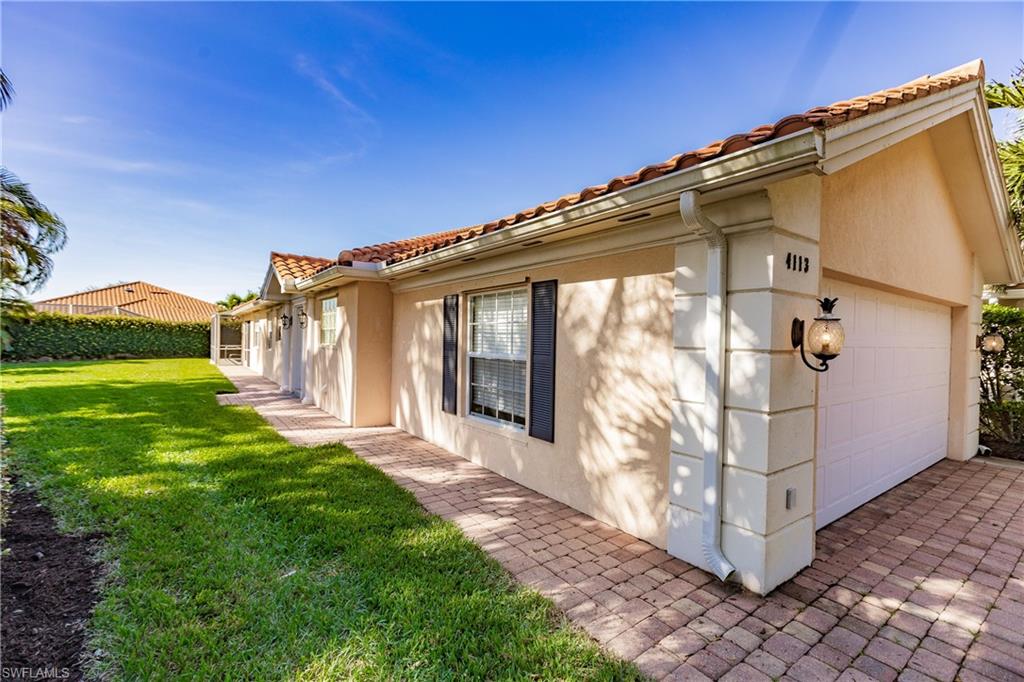 4113 Tabago Lane Naples, FL 34119 - Photo 3 of 50 View of home's exterior featuring a yard