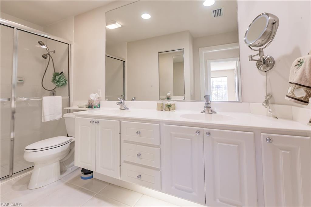 4113 Tabago Lane Naples, FL 34119 - Photo 31 of 50 Bathroom featuring toilet, vanity, tile patterned floors, and a shower with door