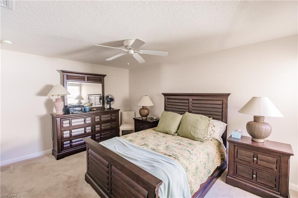 4113 Tabago Lane Naples, FL 34119 - Photo 35 of 50 Carpeted bedroom featuring ceiling fan and a textured ceiling