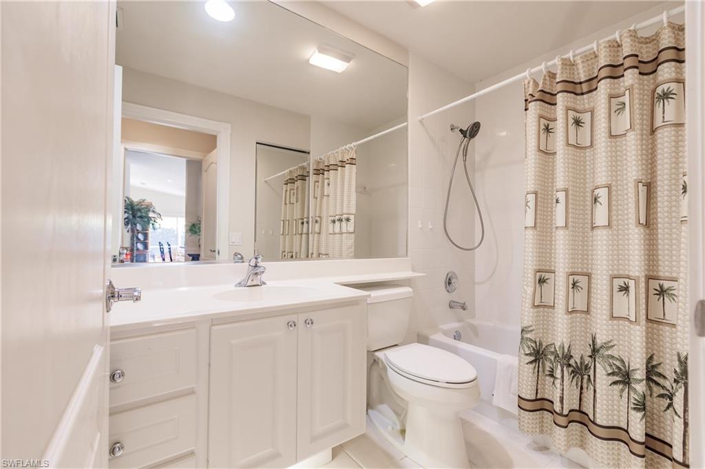 4113 Tabago Lane Naples, FL 34119 - Photo 36 of 50 Full bathroom with toilet, shower / bath combination with curtain, vanity, and tile patterned floors