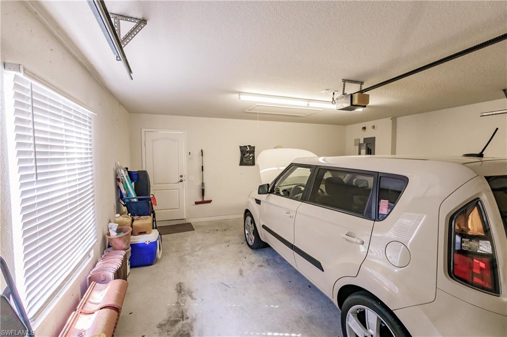 4113 Tabago Lane Naples, FL 34119 - Photo 38 of 50 Garage with electric panel and a garage door opener