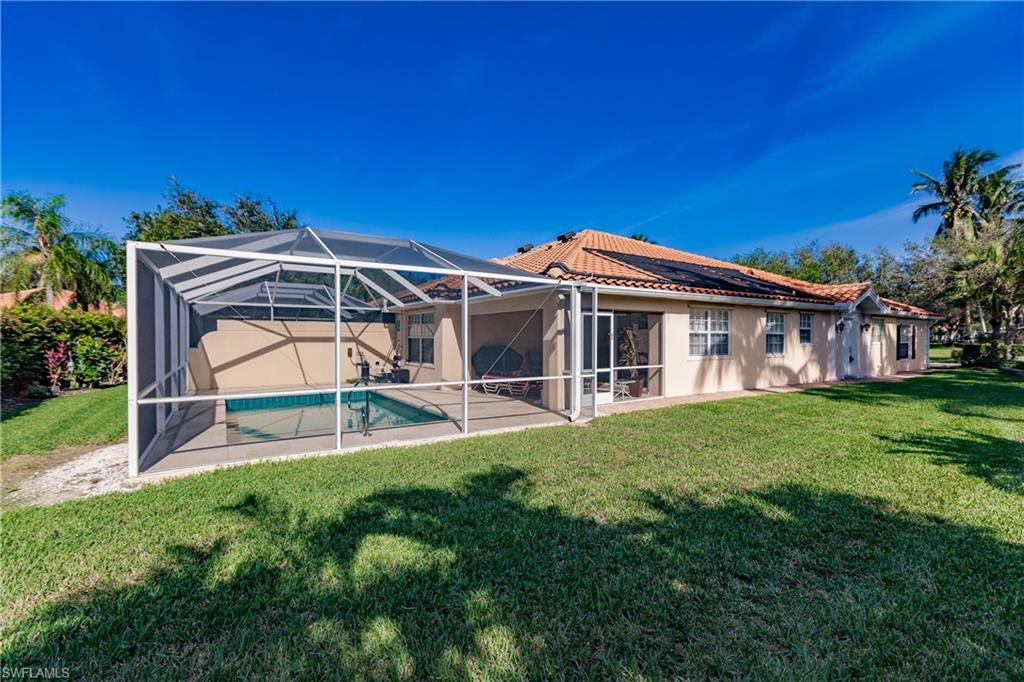 4113 Tabago Lane Naples, FL 34119 - Photo 40 of 50 Back of property featuring a lanai and a yard