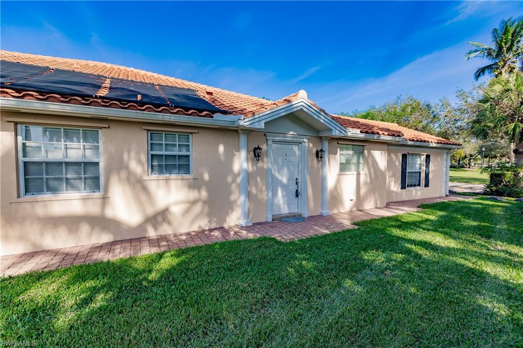 4113 Tabago Lane Naples, FL 34119 - Photo 7 of 50 View of front facade with a front yard