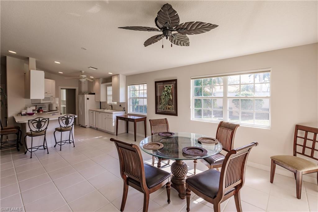4113 Tabago Lane Naples, FL 34119 - Photo 10 of 50 Tiled dining area with ceiling fan and sink