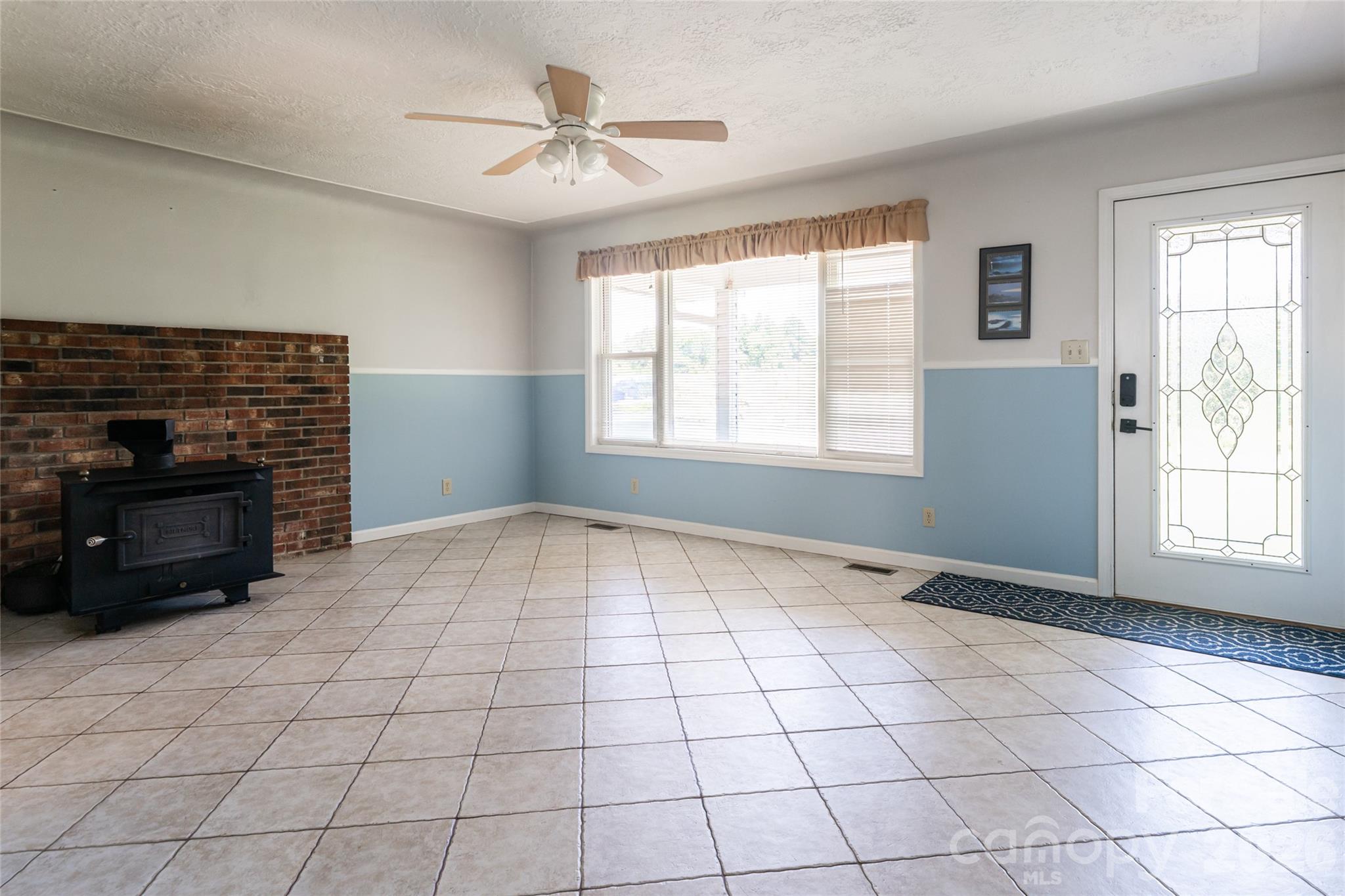 2800 Coxe Road Tryon, NC 28782 - Photo 6 of 40 a view of an empty room with window and chandelier fan