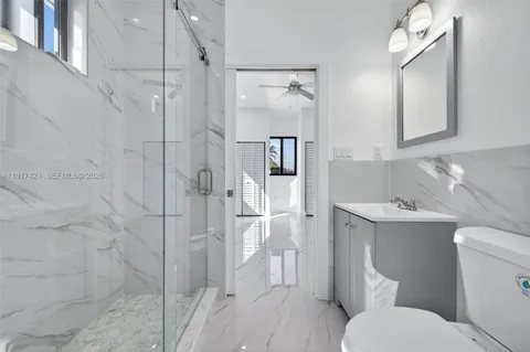 a white toilet sitting next to a bathroom sink