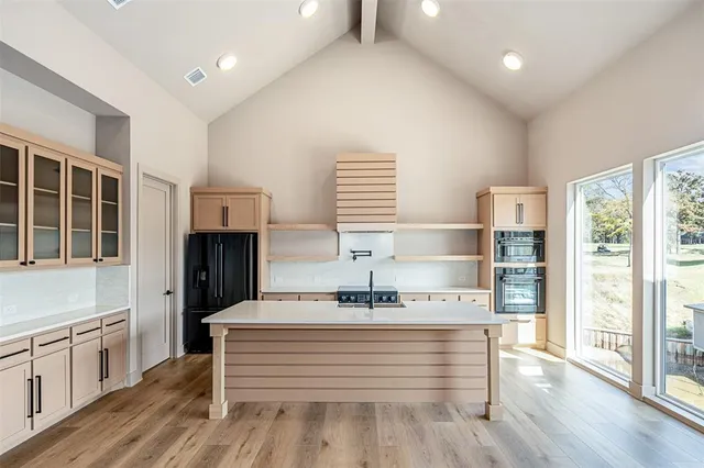 a view of hall way with furniture and wooden floor