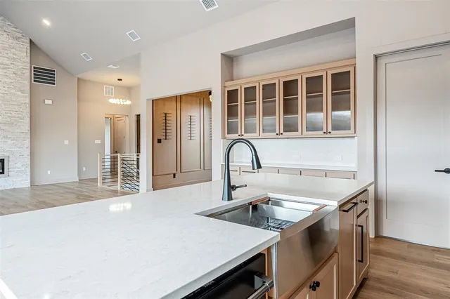 a kitchen with a kitchen island a sink stainless steel appliances and cabinets