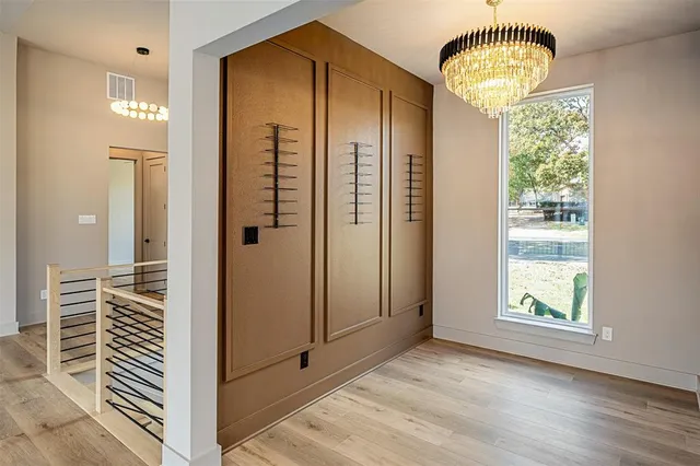 a view of a livingroom with wooden floor and a large window