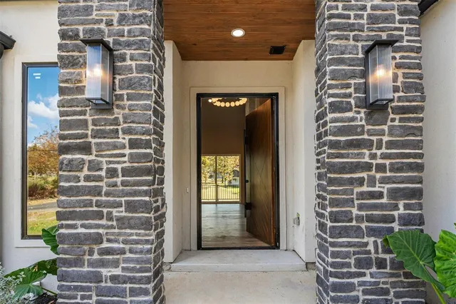 a view of a door with brick walls