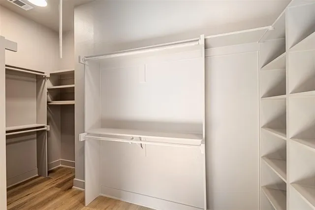 a view of walk in closet with empty racks