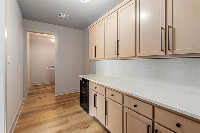 a view of a kitchen with white cabinets